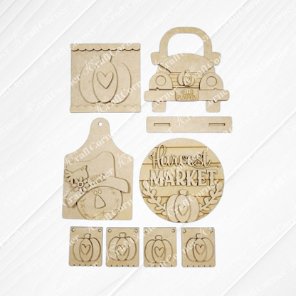 Janet's Craft Corner unfinished wood fall harvest decor craft kit featuring pumpkin, truck, and scarecrow designs.