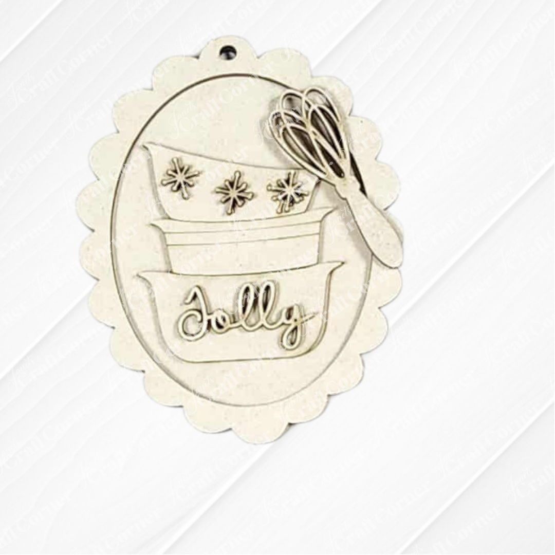 Janet's Craft Corner's Christmas Baking Ornaments DIY craft kit features a scalloped oval ornament with three stacked bowls ("Jolly" on the bottom), snowflakes, and a whisk—perfect for holiday décor or crafting. Choice of 5 designs.
