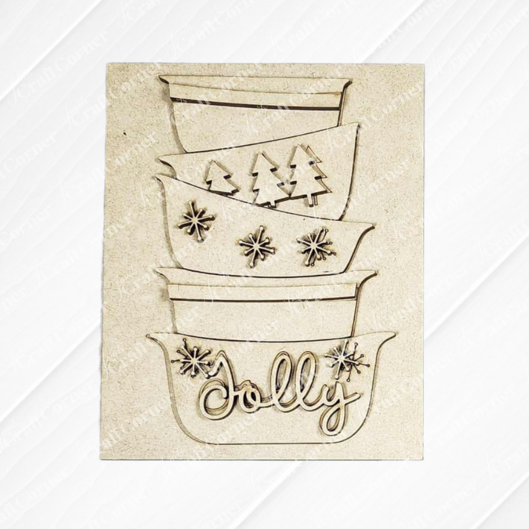 Janet's Craft Corner Christmas Baking Switchable Farmhouse Signs DIY kit includes three stackable signs: one plain, one with tree designs, and one with "Jolly" and snowflakes—perfect for festive farmhouse decor.