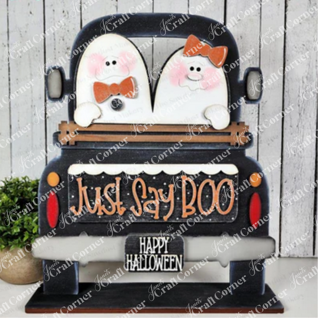 Janet's Craft Corner's Just Say Boo Interchangeable Insert craft kit includes two ghost with orange bows and signs that say "Just Say Boo" and "Happy Halloween"—perfect DIY Halloween decor or insert for your home, featuring three cute pieces displayed on a black antique truck base.