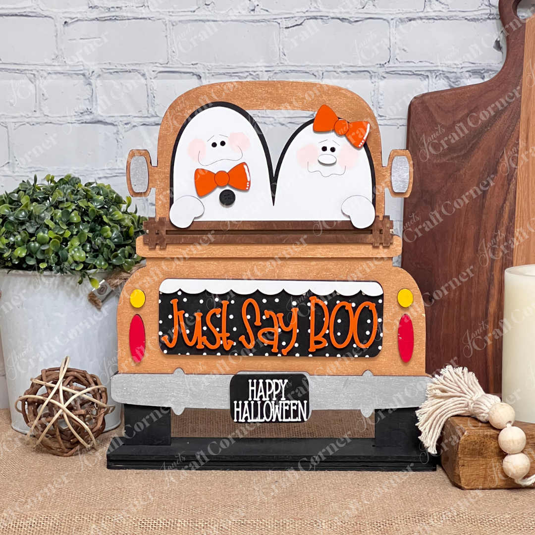 Janet's Craft Corner's Just Say Boo Interchangeable Insert craft kit includes two ghost with orange bows and signs that say "Just Say Boo" and "Happy Halloween"—perfect DIY Halloween decor or insert for your home, featuring three cute pieces displayed on a copper antique truck  base.
