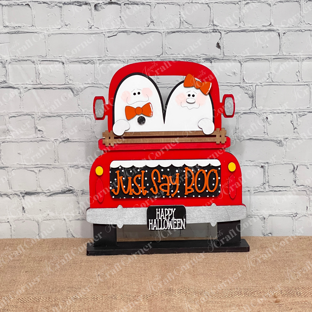 Janet's Craft Corner's Just Say Boo Interchangeable Insert craft kit includes two ghost with orange bows and signs that say "Just Say Boo" and "Happy Halloween"—perfect DIY Halloween decor or insert for your home, featuring three cute pieces displayed on a red antique truck base.