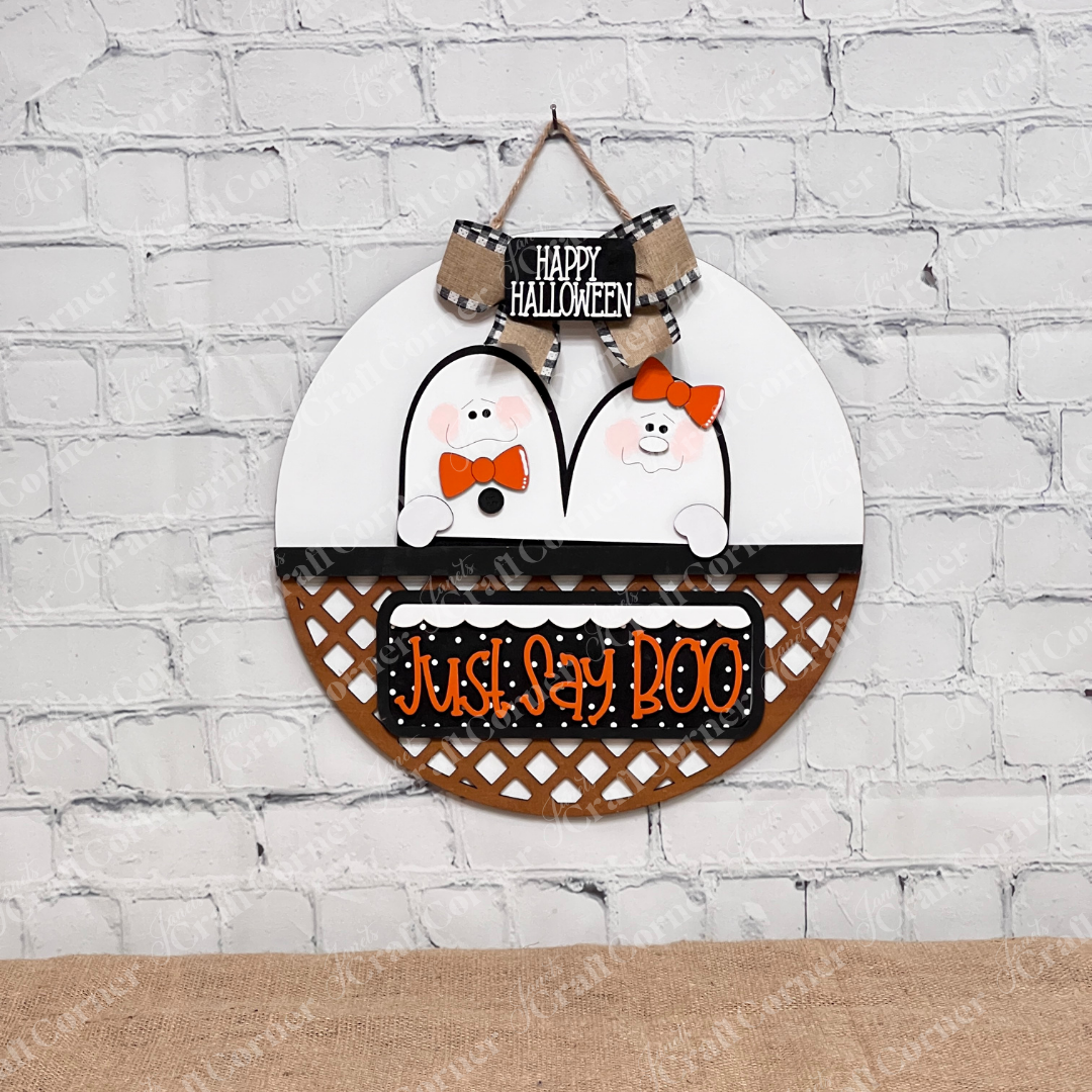 Janet's Craft Corner's Just Say Boo Interchangeable Insert craft kit includes two ghost with orange bows and signs that say "Just Say Boo" and "Happy Halloween"—perfect DIY Halloween decor or insert for your home, featuring three cute pieces displayed on a white door hanger base.