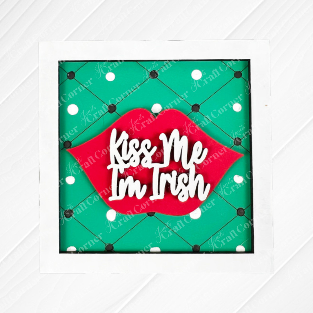 Add a playful touch to your display with Janet's Craft Corner St Patricks Squares—a decorative sign featuring red lips and "Kiss Me I'm Irish" on a green polka-dot background, perfect for tiered trays or wood cut-out collections.