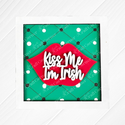 Add a playful touch to your display with Janet's Craft Corner St Patricks Squares—a decorative sign featuring red lips and "Kiss Me I'm Irish" on a green polka-dot background, perfect for tiered trays or wood cut-out collections.