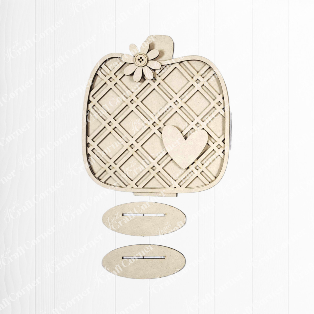 A beige, pumpkin-shaped ornament with a lattice pattern, flower top, and heart accents—an ideal autumn accent from Janet's Craft Corner—displayed above two matching Fall Harvest Mini Shelf Sitters DIY kits.