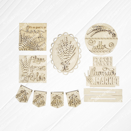 The Lavender Decor Set by Janet's Craft Corner features laser-cut wooden pieces for DIY home decor, including pinecones, leaves, and phrases like “Hello” and “Love grows here.” Includes banners and plaques—perfect unfinished wood craft kit.