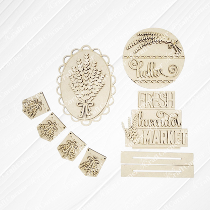 The Lavender Decor Set by Janet's Craft Corner features unfinished wood cut-outs—sprigs, “hello,” “FRESH lavender MARKET,” banners, and frames—ideal for DIY home decor. All pieces are displayed on a white background.