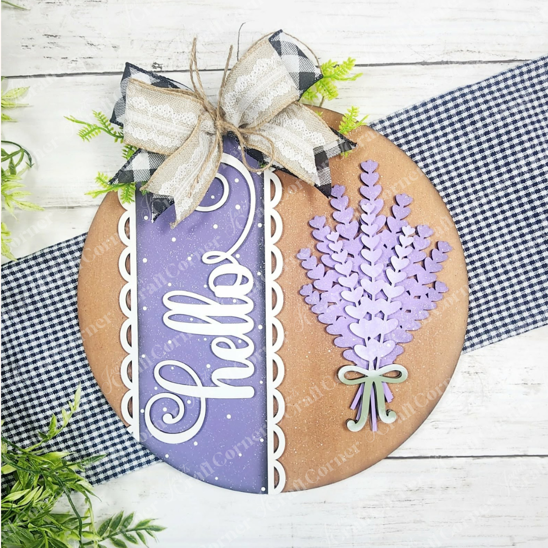 The Lavender Hello Door/Wall Hanger by Janet's Craft Corner is a DIY home decor craft kit with a round wood sign, bow, and lavender sprigs. Comes in 2 sizes, perfect for seasonal farmhouse style. Set of 1.