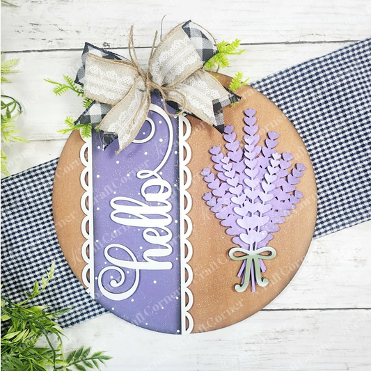 The Lavender Hello Door/Wall Hanger by Janet's Craft Corner is a DIY home decor craft kit with a round wood sign, bow, and lavender sprigs. Comes in 2 sizes, perfect for seasonal farmhouse style. Set of 1.