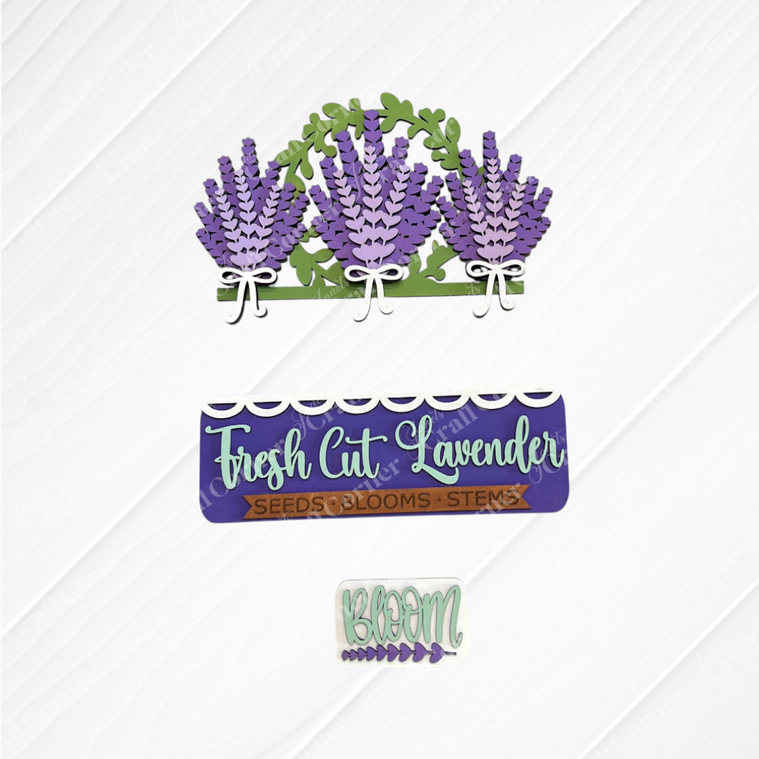 The Lavender Interchangeable Insert from Janet's Craft Corner features purple lavender with green leaves, a "Fresh Cut Lavender" sign with "Seeds • Blooms • Stems," and a small "BLOOM" sign—ideal for seasonal DIY home decor.