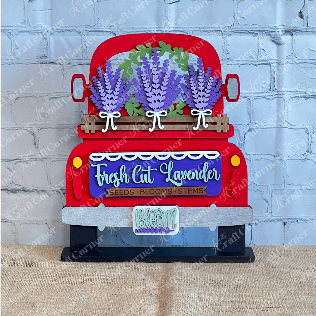 The Lavender Interchangeable Insert – DIY Craft Kit by Janet's Craft Corner features a red truck with purple lavender, “Fresh Cut Lavender” sign, and “BLOOM” plate—perfect farmhouse décor for lavender lovers, shown against a brick wall backdrop.