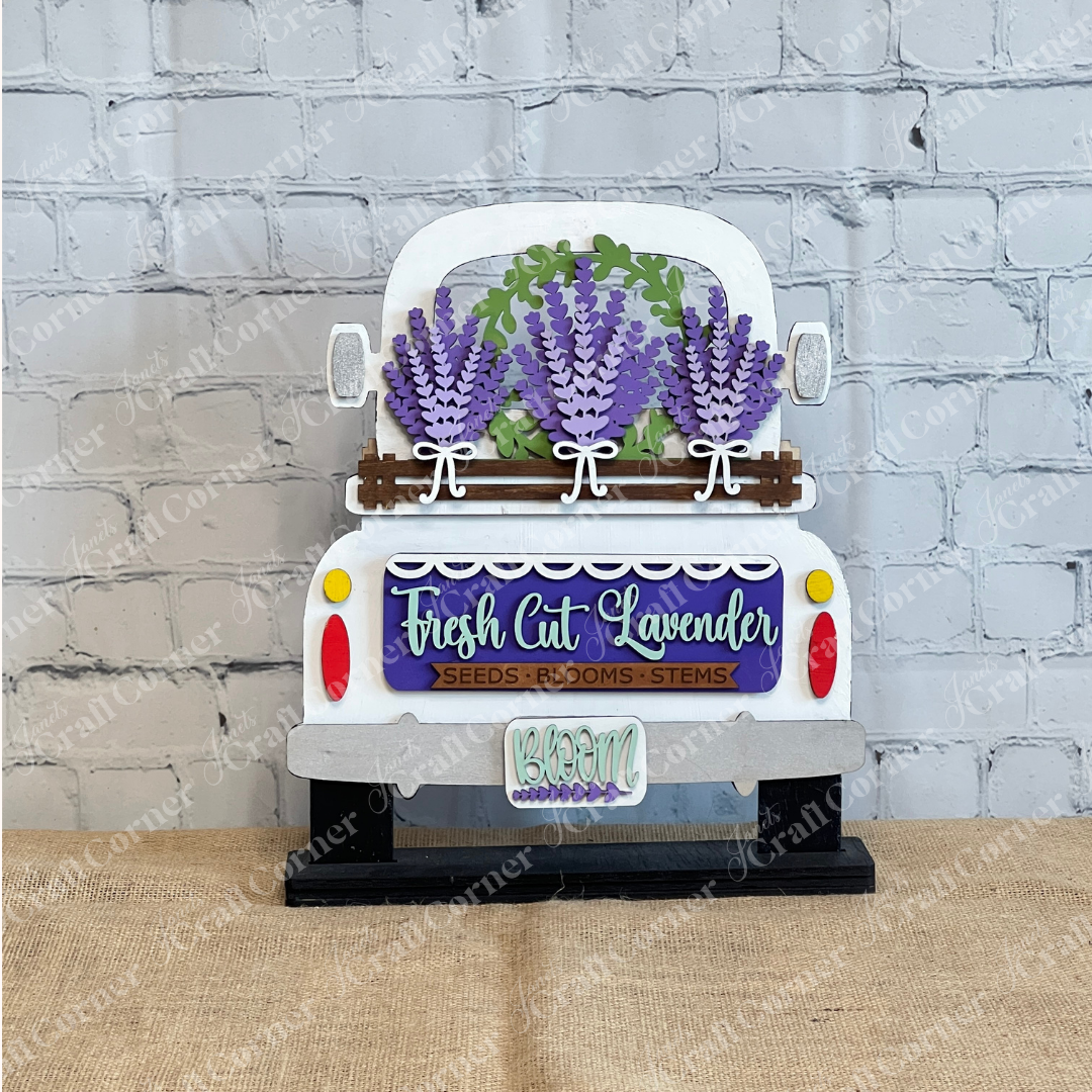 The Lavender Interchangeable Insert – DIY Craft Kit by Janet's Craft Corner features a white vintage truck loaded with purple lavender and reads "Fresh Cut Lavender: Seeds - Blooms - Stems" and "Bloom"—perfect for farmhouse or lavender décor.