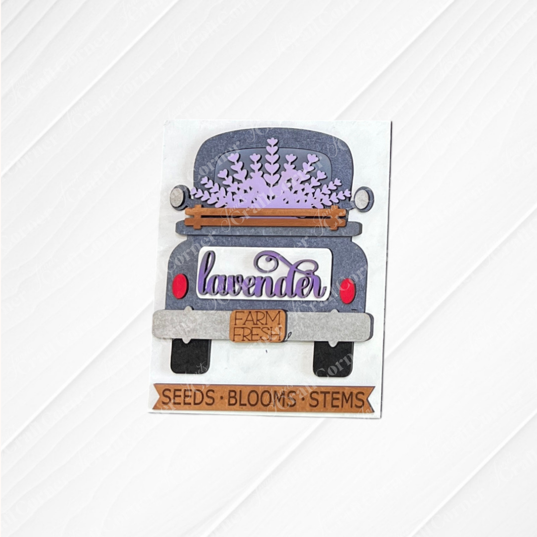 Janet's Craft Corner's Lavender Switchable Farmhouse Signs DIY kit features a vintage truck with lavender and tiered tray signs—"lavender," "FARM FRESH," and "SEEDS • BLOOMS • STEMS" on light wood—perfect for small space decor. Set of 1.