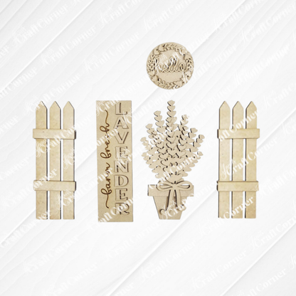 The Lavender Interchangeable Porch Set by Janet's Craft Corner includes five unfinished wood cutouts—two picket fences, a “Lavender” sign, a potted lavender plant, and a round “hello” sign—perfect for DIY seasonal home decor.