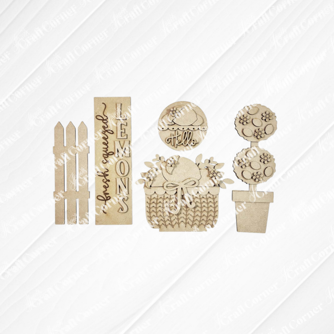 The Lemons Interchangeable Porch Set by Janet's Craft Corner features wooden picket fence cutouts, a "fresh squeezed LEMONS" sign, "hello" leaf circle, lemon basket with bow, and flower designs—perfect for DIY seasonal home decor.