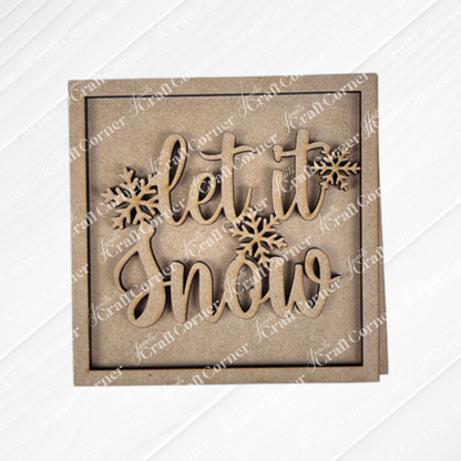 The Snow Squares by Janet's Craft Corner is a square wooden sign with "let it snow" in cursive and two snowflake cutouts—ideal for DIY seasonal decor or your Swappable Square Displays, all on a light textured background.