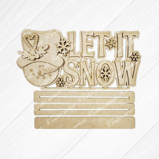 Add a festive touch to your space with the Let It Snow Word Art Shelf Sitter from Janet’s Craft Corner. This DIY home décor craft kit features a charming wooden sign with a smiling snowman wearing a hat adorned with flowers next to the phrase “Let It Snow.” Three blank slots below offer plenty of room for customizable text, while snowflake shapes accent the design, making it an inviting addition to your winter decorations or as a personalized seasonal shelf sitter. Set includes 1 craft kit.