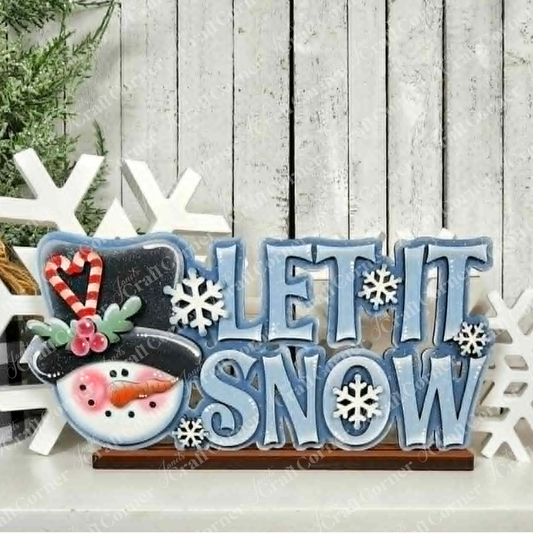 Add a festive touch to your winter décor with Janet’s Craft Corner Let It Snow Word Art Shelf Sitter, a DIY home decor craft kit featuring a snowman head, candy cane, delicate snowflakes, and bold blue “LET IT SNOW” lettering on rustic wood with white snowflake accents—perfect for brightening your home this season.