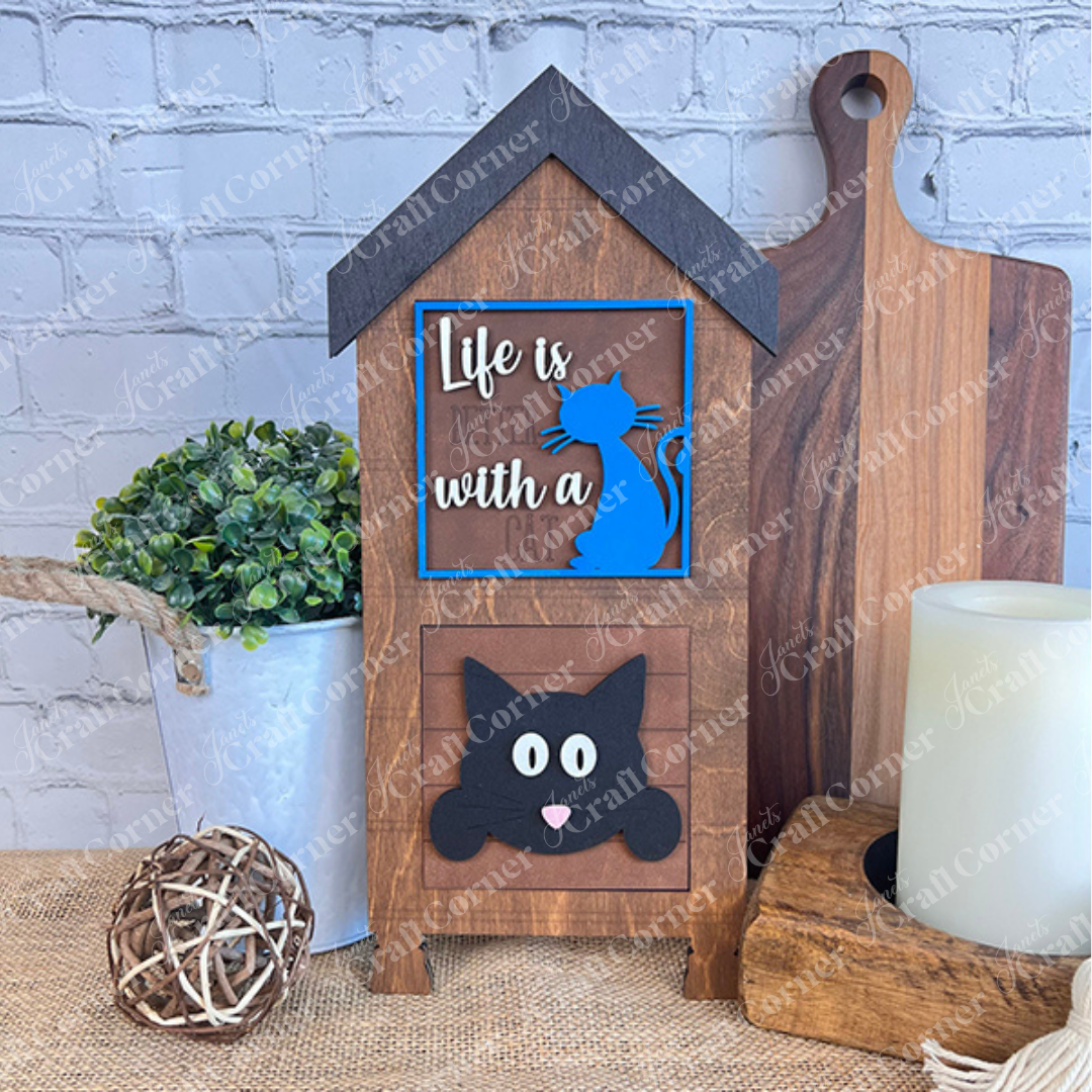 Janet's Craft Corner Cat Swappable Squares: This wooden, house-shaped sign with "Life is better with a cat," blue cat silhouette, and black cat face is perfect small-space or seasonal DIY decor. Display on a table with plants or candles.