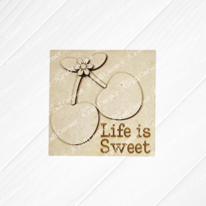 Cherry Squares DIY craft kit from Janet's Craft Corner includes a wooden cutout with two cherries, leaves, and "Life is Sweet" engraved—perfect for charming tiered tray decor on a light beige background.