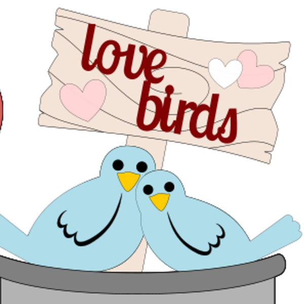 Illustration of two blue birds cuddling on a branch with a wooden sign behind them that reads "love birds" in red letters. Pink and white hearts decorate the sign, making it an ideal addition to your DIY projects for Valentine's, brought to you by Janet's Craft Corner as the Love Birds Train Inserts.