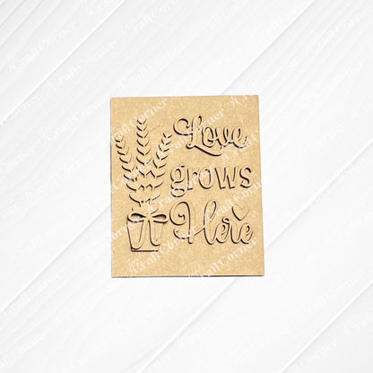 Janet's Craft Corner offers the Lavender Switchable Farmhouse Signs DIY craft kit—a wooden sign featuring leafy branches in a pot and "Love grows here," perfect for small spaces or tiered trays. Set of 1.