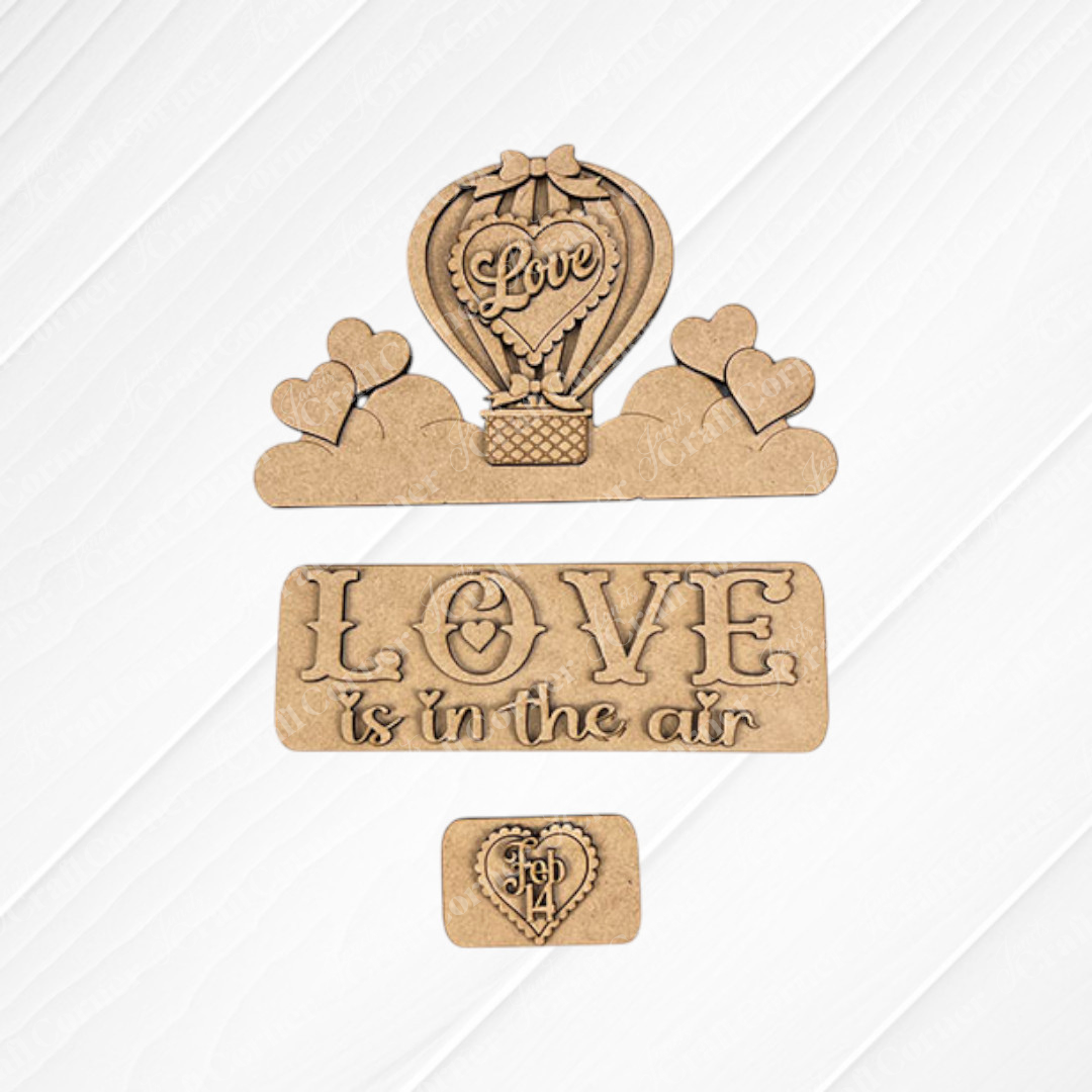 Transform your space with Janet's Craft Corner's "Love is in the Air Interchangeable Insert" DIY home decor kit. This charming set includes wooden craft pieces on textured burlap, showcasing a hot air balloon adorned with "Love," hearts floating on clouds, and the phrase "LOVE is in the air." It's an ideal hand-painted DIY craft kit to bring creativity and charm to your February 14 celebrations.