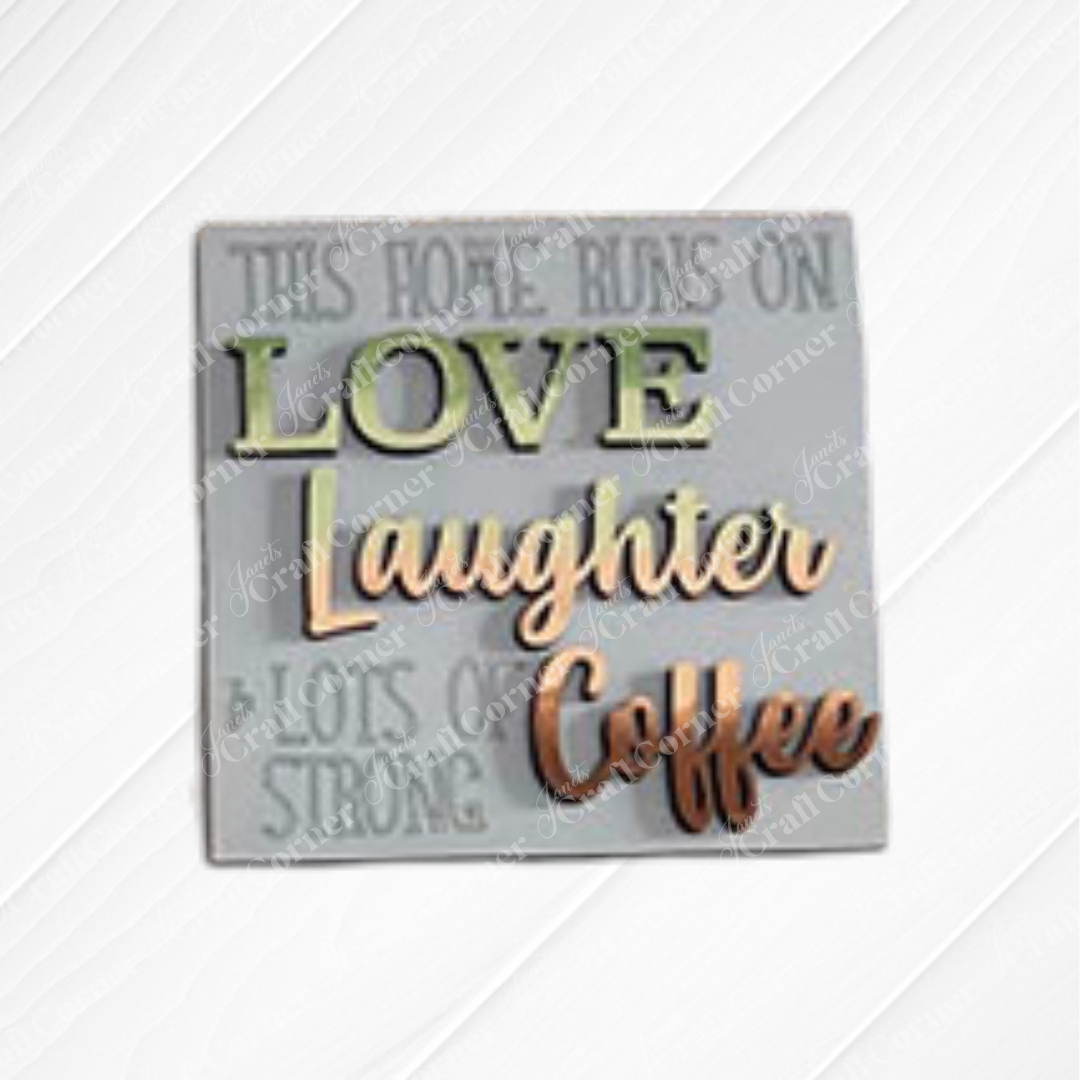 Janet's Craft Corner presents Coffee Bar Swappable Squares—a decorative wooden sign with a green and brown message, "This home runs on love, laughter & lots of strong coffee" displayed on a white wooden background
