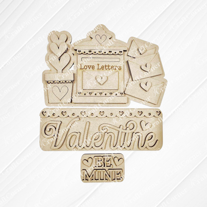 Janet's Craft Corner presents the Love Letters Interchangeable Insert: hand-painted wooden Valentine's cutouts including a "Love Letters" mail slot, a "Valentine" sign, and a "Be Mine" plaque with heart details on burlap over a textured white background.