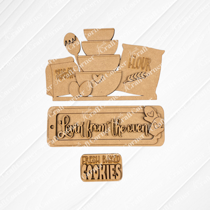 Introducing the "Lovin from the Oven Interchangeable Insert" DIY home decor kit by Janet's Craft Corner. This charming set features hand-painted wooden kitchen-themed cutouts including bowls, eggs, sugar, and flour bags on a textured background. Two delightful plaques read "Lovin' from the oven" with hearts and "Fresh baked cookies." The kit provides interchangeable inserts for a personalized decor touch that’s ideal for any kitchen space.