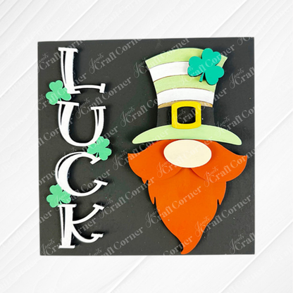 The Lucky Irish Squares by Janet's Craft Corner feature "LUCK" spelled vertically with shamrocks and a gnome in a green hat and orange beard on black wood cut-outs—perfect for charming, swappable St. Patrick’s Day tray decor.