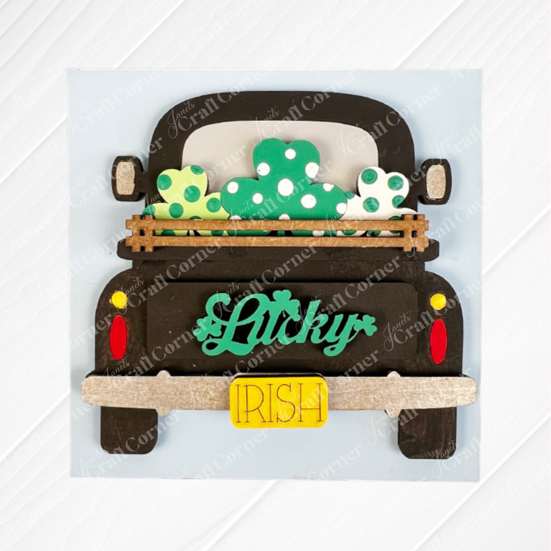 Janet's Craft Corner’s Lucky Irish Squares sign shows a black truck with three green and white shamrocks, a "Lucky" tailgate, and yellow "Irish" plate—ideal for tiered tray decor or pairing with Swappable Squares wood cut-outs.