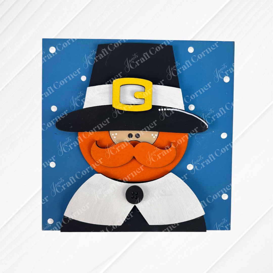 The Harvest Blessings Thanksgiving Squares by Janet's Craft Corner feature a cute orange-bearded cartoon pilgrim in a black hat with a yellow buckle, set on a blue polka dot background—perfect festive decor for Swappable Squares displays.