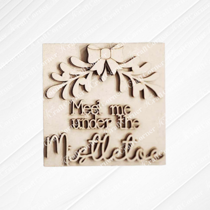 The Mistletoe Swappable Squares DIY kit by Janet's Craft Corner features festive wood pieces with bows and leaves, ideal for tiered trays or mixing with other cut-outs for seasonal home decor. Choose from 4 designs.