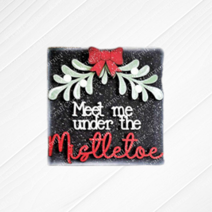 The Mistletoe Swappable Squares DIY craft kit from Janet's Craft Corner features a square wood sign with a red bow, green mistletoe, and festive text—perfect for tiered trays or your Swappable Squares collection. Choice of 4 designs.