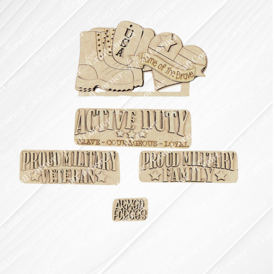Janet's Craft Corner presents the Military Interchangeable Insert, a DIY home decor kit featuring wooden cutouts with military-themed messages on a gray surface. The set includes shapes like a boot with the phrases "USA" and "Home of the Brave," as well as rectangles displaying messages such as "Proud Military Family" and "Active Duty." This kit is ideal for enhancing your DIY projects or adding a patriotic touch to your home decor.