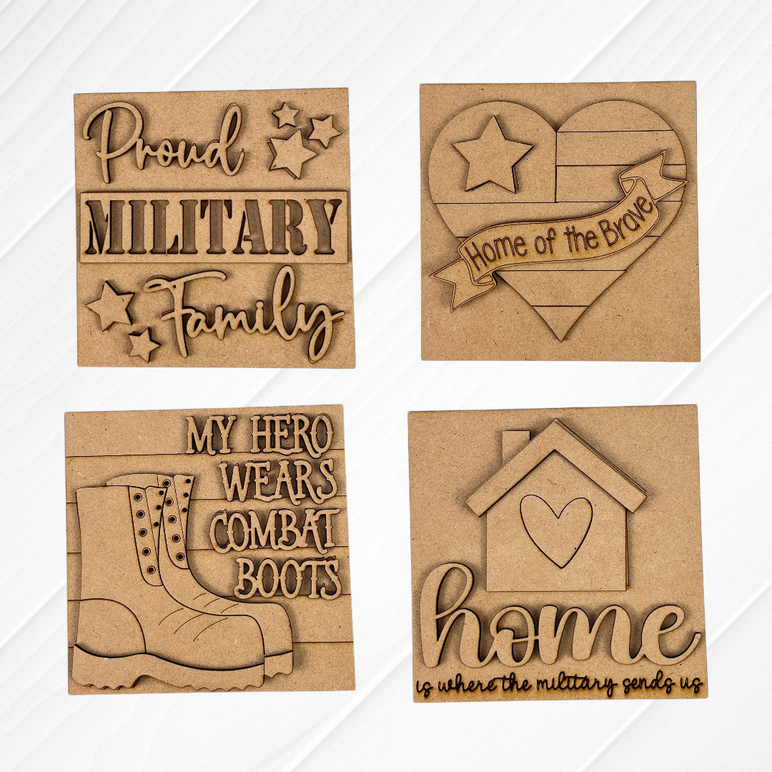 Janet's Craft Corner Military Squares are four wood plaques with engraved, cutout designs: “Proud Military Family,” a heart with “Home of the Brave,” combat boots, and a house, perfect for tiered tray décor.