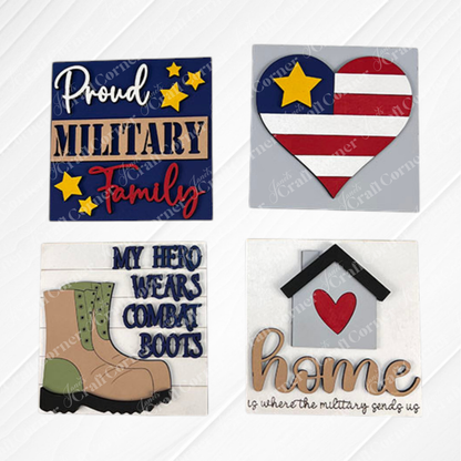 Military Squares by Janet's Craft Corner features four swappable tiles: "Proud Military Family" with stars, a flag heart, boots with "My Hero Wears Combat Boots," and "Home is where the military sends us"—perfect tiered tray decor!.