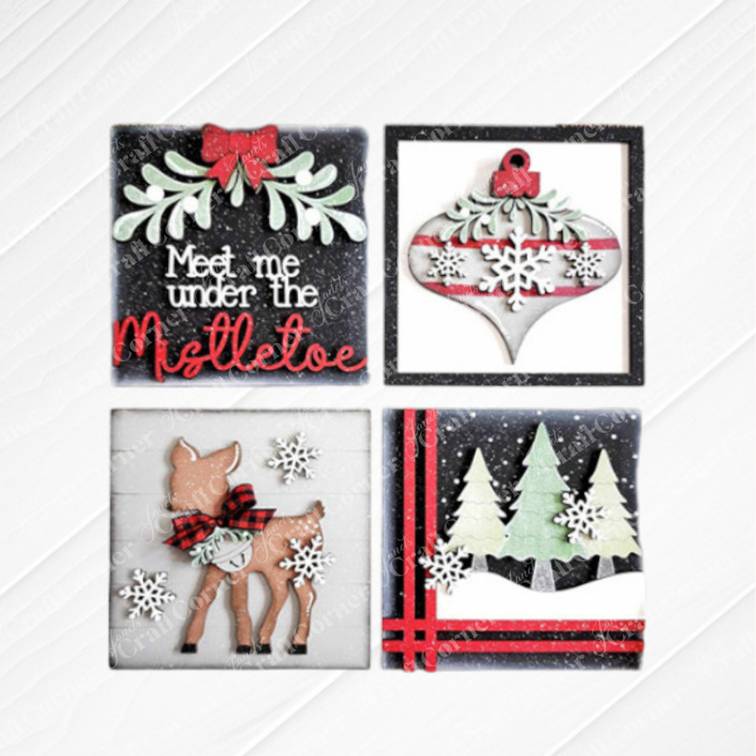 Janet's Craft Corner Mistletoe Swappable Squares DIY kit includes four Christmas-themed designs: "Meet me under the mistletoe" text, a snowflake ornament, a scarfed deer, and snowy trees with red ribbon accents.