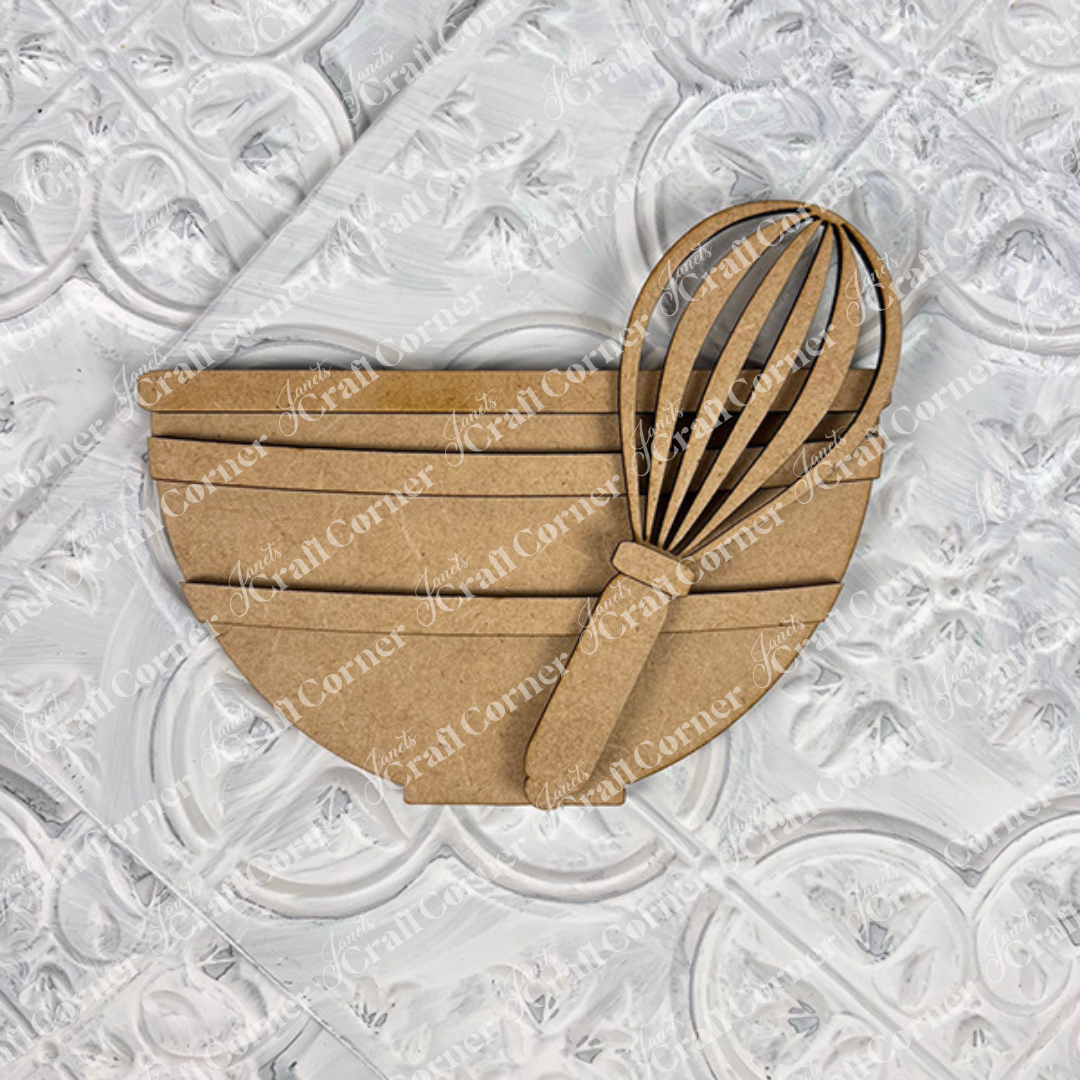 The Vintage Santa Cookies Decor Set by Janet's Craft Corner is a DIY craft kit of brown cardboard mixing bowl and whisk cutouts, ideal for Holiday Home Decor or tiered trays, shown on a textured white surface.