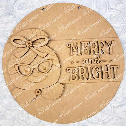 Janet's Craft Corner Mrs. Claus Merry & Bright Round Sign is a DIY seasonal home decor craft kit featuring a smiling snowman face with glasses and bow, textured background, “Merry & Bright” text, and holes for hanging. Set of 1.