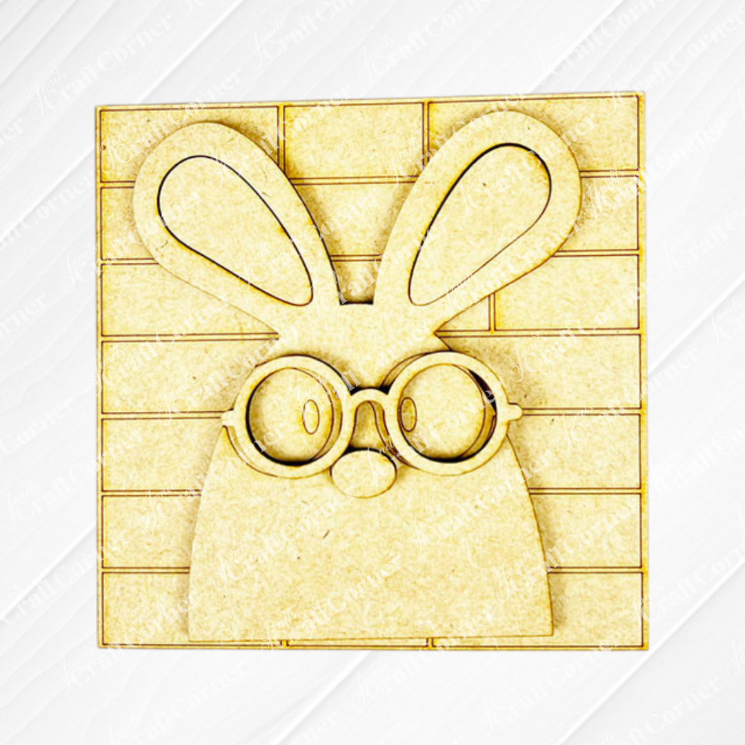 The Easter Bunny Squares by Janet's Craft Corner features a wooden cutout bunny with big ears and round glasses on a Swappable Squares grid, perfect for adding charm to your tiered tray decor or wood cut-out collection.