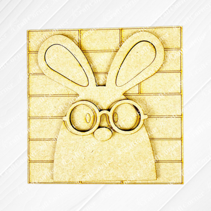 The Easter Bunny Squares by Janet's Craft Corner features a wooden cutout bunny with big ears and round glasses on a Swappable Squares grid, perfect for adding charm to your tiered tray decor or wood cut-out collection.