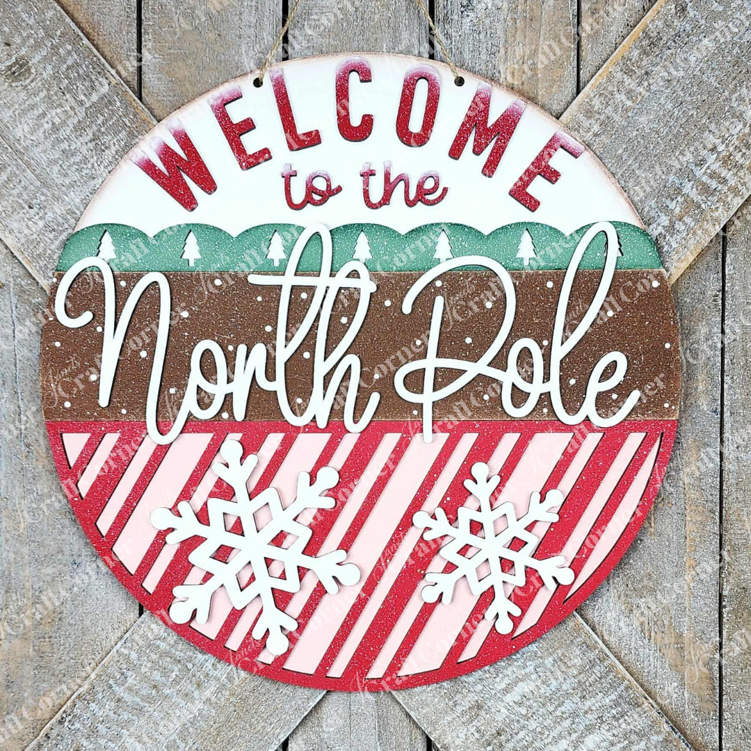 Add a festive touch with Janet's Craft Corner North Pole Door/Wall Hanger—a DIY seasonal home decor craft kit featuring “Welcome to the North Pole,” snowflakes, and more. Set of 1, perfect for doors or walls!.