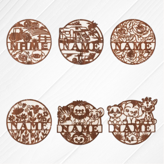 Janet's Craft Corner Nursery Name Wall Hanger set includes six unfinished round wood plaques in truck, bulldozer, floral, wildflowers, woodland, and zoo animal designs. Each has a customizable "NAME" space—ideal for DIY nursery decor.