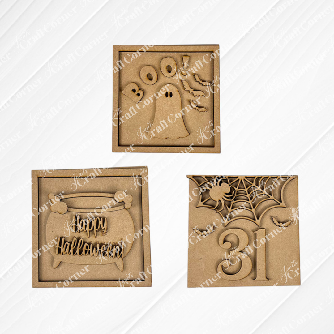 The Oct 31 Squares by Janet's Craft Corner includes three wood cut-outs for Swappable Squares: "BOO!" with a ghost, "Happy Halloween" in a pumpkin, and a spiderweb with 31—perfect for tiered tray decor.