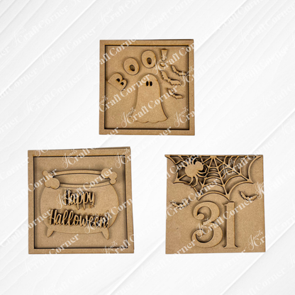 The Oct 31 Squares by Janet's Craft Corner includes three wood cut-outs for Swappable Squares: "BOO!" with a ghost, "Happy Halloween" in a pumpkin, and a spiderweb with 31—perfect for tiered tray decor.