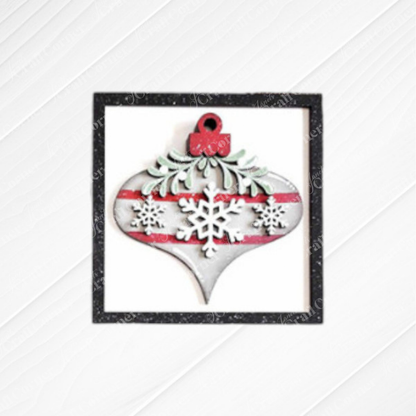 Janet's Craft Corner Mistletoe Swappable Squares DIY kit features a wood cut-out ornament with red stripes, white snowflakes, and green foliage in a black glitter square—ideal for tiered trays or holiday decor. Choice of 4 designs!.
