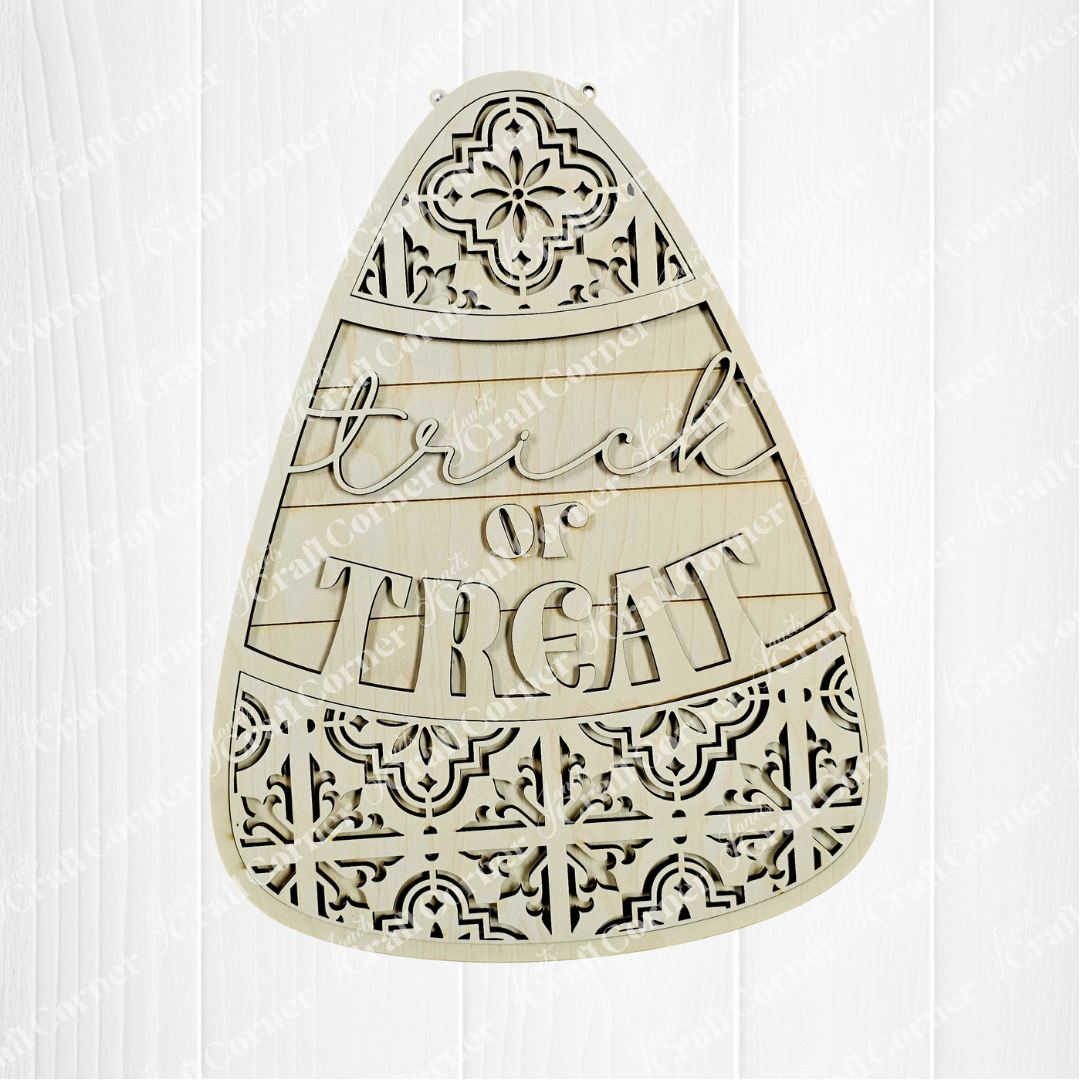Decorative wooden cutout shaped like a candy corn with 'Trick or Treat' text on a white background